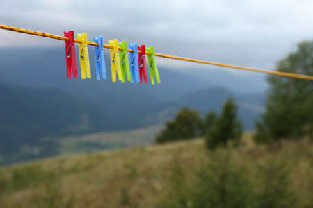 Colorful clothespins hanging on washing line in mountainsの写真素材
