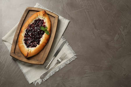 Delicious sweet cottage cheese pastry with cherry jam served on gray table, flat lay. Space for textの写真素材