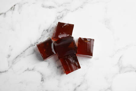 Heap of delicious grass jelly cubes on white marble table, flat layの写真素材