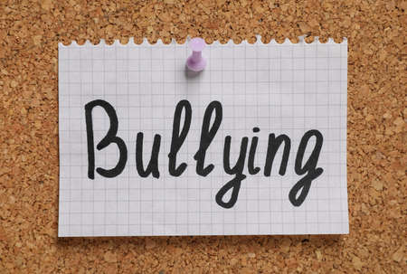Note with phrase Stop Bullying pinned to cork board, closeupの写真素材