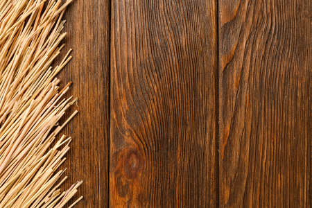 Dried hay on wooden background, flat lay. Space for textの写真素材
