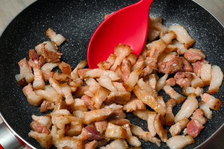 Cooking cracklings in frying pan, closeup. Pork lardの写真素材