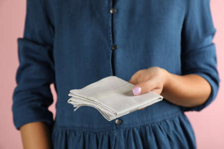 Woman holding handkerchief against pink background, closeupの写真素材