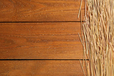 Dried hay on wooden background, flat lay. Space for textの写真素材