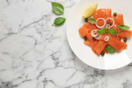 Delicious salmon carpaccio served on white marble table, flat lay. Space for textの写真素材