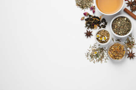 Composition with fresh brewed tea and dry leaves on white background, top viewの写真素材