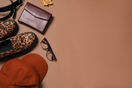 Flat lay composition with stylish hat on brown background, space for textの写真素材