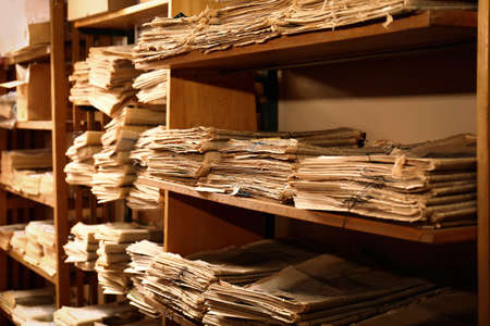 Collection of old newspapers on shelves in libraryの写真素材