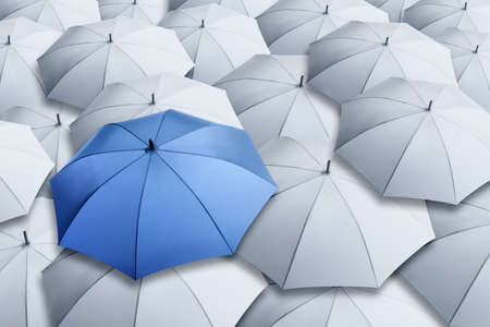 Blue umbrella standing out of other ones, above viewの写真素材
