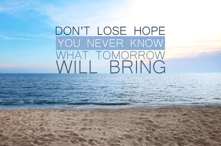 Don't Lose Hope You Never Know What Tomorrow Will Bring. Inspirational quote saying about patience, belief in yourself and next day. Text against sandy beach and seaの写真素材