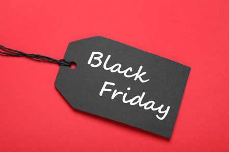Black Friday tag on red background, top viewの写真素材