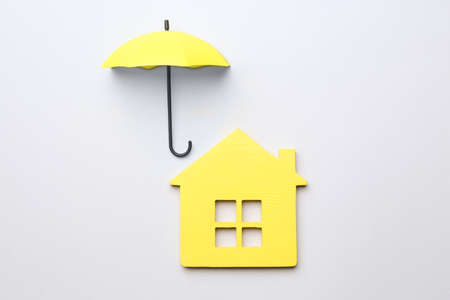 Mini umbrella and house model on white background, top viewの写真素材