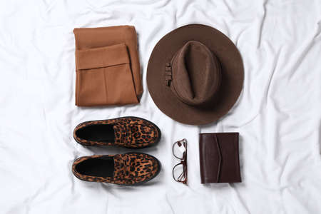 Flat lay composition with stylish hat on white fabricの写真素材
