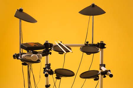 Modern electronic drum kit on yellow background. Musical instrumentの写真素材