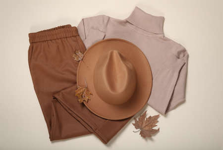 Flat lay composition with stylish hat and clothes on beige backgroundの写真素材