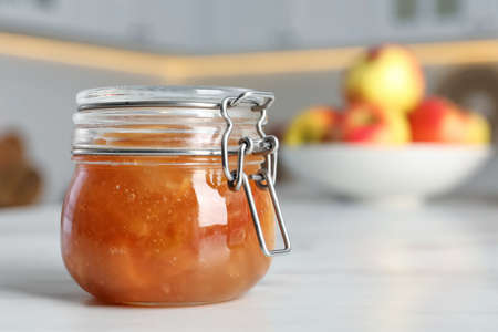 Delicious apple jam on white table, closeup. Space for textの写真素材