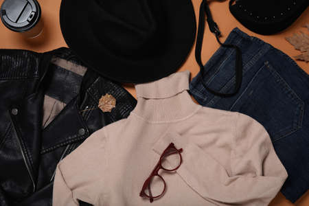 Flat lay composition with stylish hat and clothes on orange backgroundの写真素材