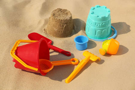 Set of plastic beach toys on sand. Outdoor playの写真素材