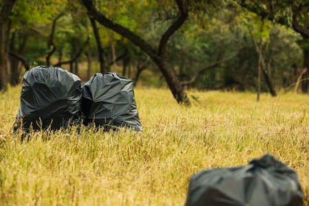 Trash bags full of garbage outdoors. Space for textの写真素材
