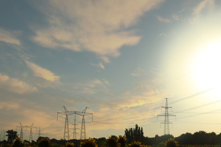 Telephone poles with cables on sunny day outdoors