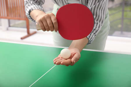 Woman playing table tennis indoors, closeup viewの写真素材