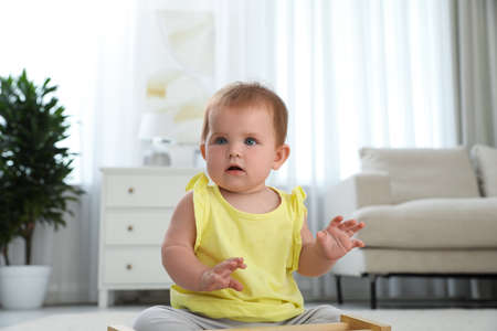 Cute little redhead baby in living roomの写真素材