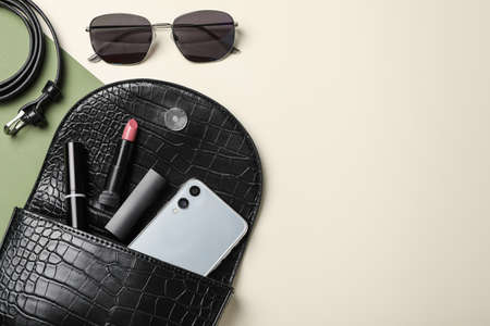 Stylish women's bag and different stuff on color background, flat lay. Space for textの写真素材