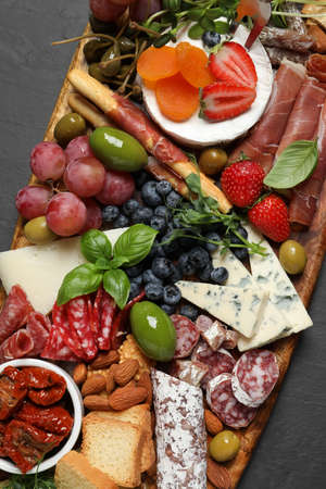 Set of different delicious appetizers served on black table, top viewの写真素材