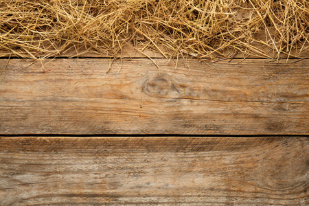 Dried hay on wooden background, flat lay. Space for textの写真素材