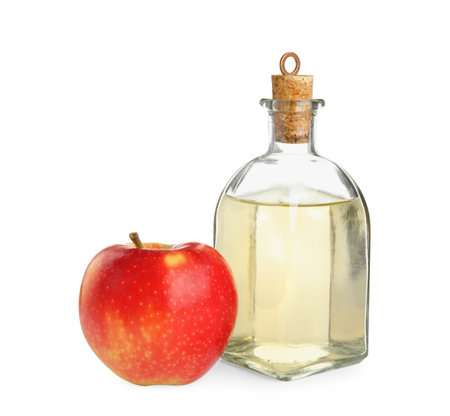 Natural apple vinegar and fresh fruit on white backgroundの写真素材