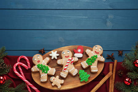 Flat lay composition with delicious Christmas cookies on blue wooden table, space for textの写真素材