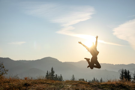Young woman training outdoors at sunrise, space for text. Fitness lifestyleの写真素材