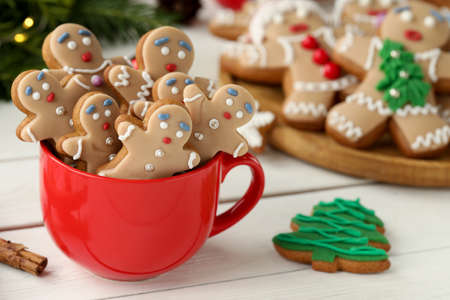 Delicious homemade Christmas cookies in cup on white wooden table. Space for textの写真素材