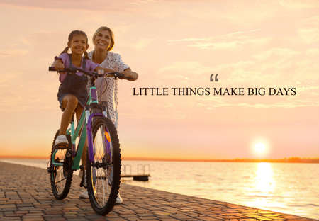 Little Things Make Big Days. Motivational quote reminding that moments of joy building up happy life or small things every day make big result. Text against view of mother teaching daughter to ride bicycle near riverの写真素材