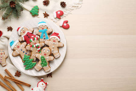 Flat lay composition with delicious Christmas cookies on beige wooden table, space for textの写真素材
