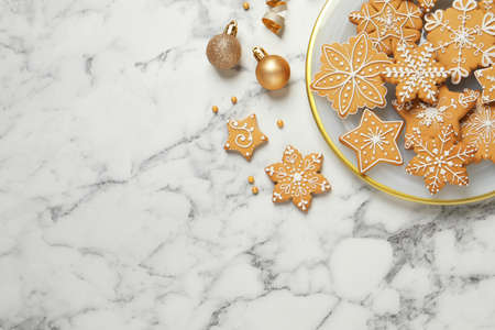 Tasty Christmas cookies and baubles on white marble table, flat lay. Space for textの写真素材