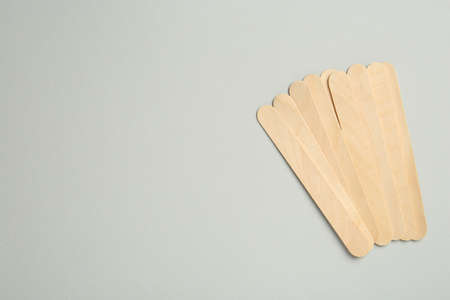 Pile of spatulas on gray background, flat lay. Space for text