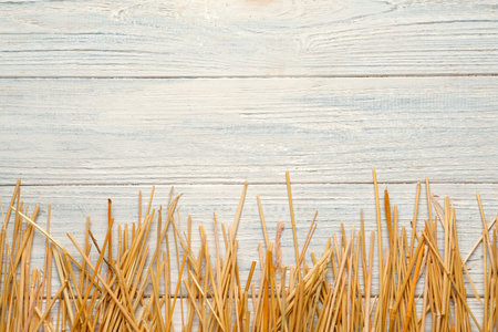 Dried hay on white wooden background, flat lay. Space for textの写真素材