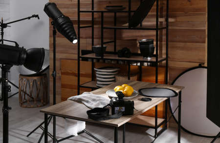 Professional equipment and many lemons on table in studio. Food photo