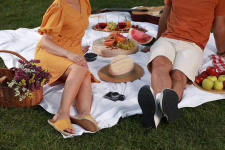 Couple having picnic outdoors on summer day, closeup
