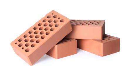 Pile of red bricks on white background. Building materialの写真素材