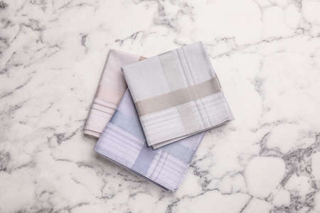 Different handkerchiefs folded on white marble table, flat layの写真素材