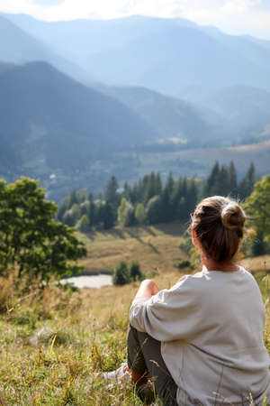 Woman enjoying beautiful mountain landscape, back view. Space for textの写真素材