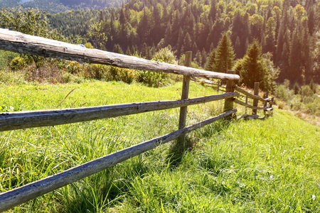 Beautiful view of mountain countryside with wooden fenceの写真素材