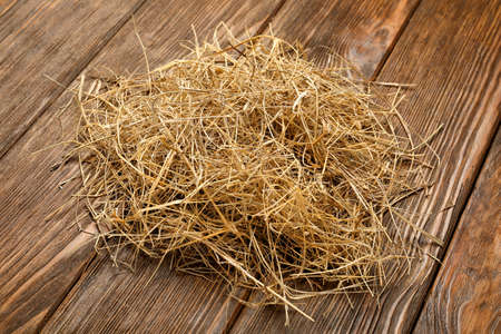Pile of dried hay on wooden backgroundの写真素材