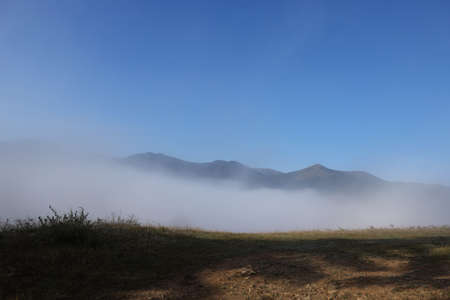 Beautiful view of landscape with foggy mountain hillsの写真素材