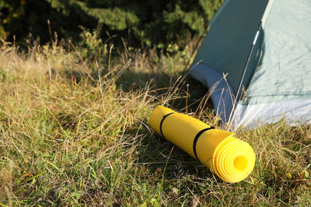 Sleeping mat near camping tent outdoors. Tourism equipmentの写真素材