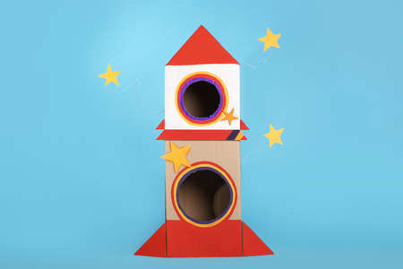 Cute handmade cardboard spaceship on light blue backgroundの写真素材