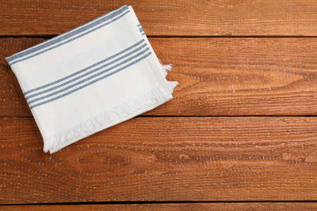Striped kitchen towel on wooden table, top view. Space for textの写真素材
