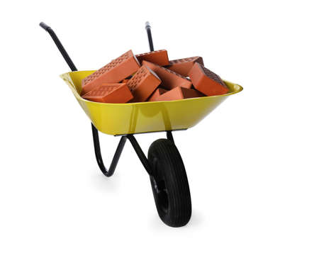 Pile of red bricks in wheelbarrow on white background. Building materialの写真素材